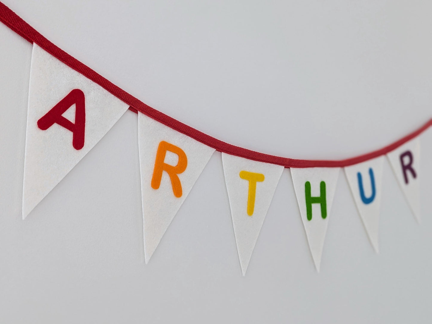 Custom personalised felt bunting with rainbow hand-cut lettering