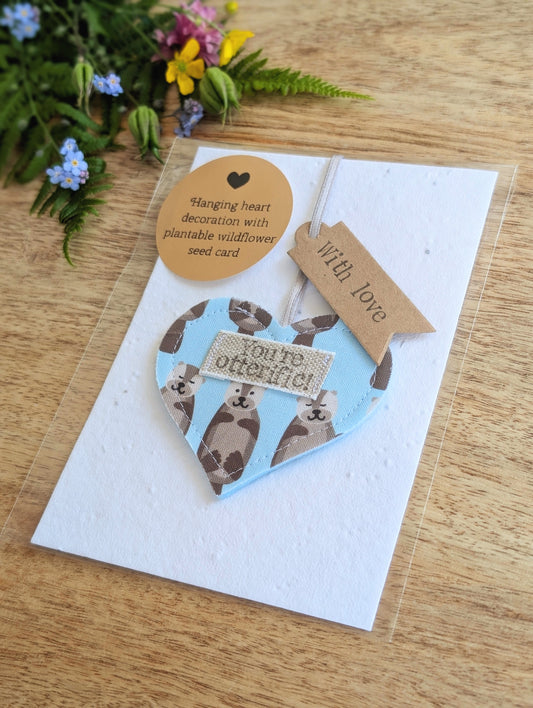 'You're otterific!' hanging heart decoration with plantable wildflower seed backing card